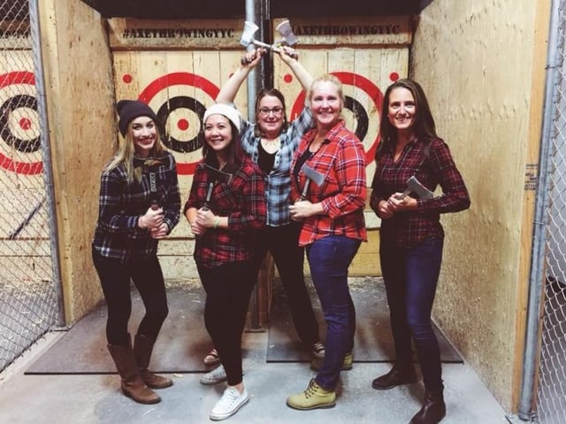  Ladies celebrating bachelorette party by axe throwing
